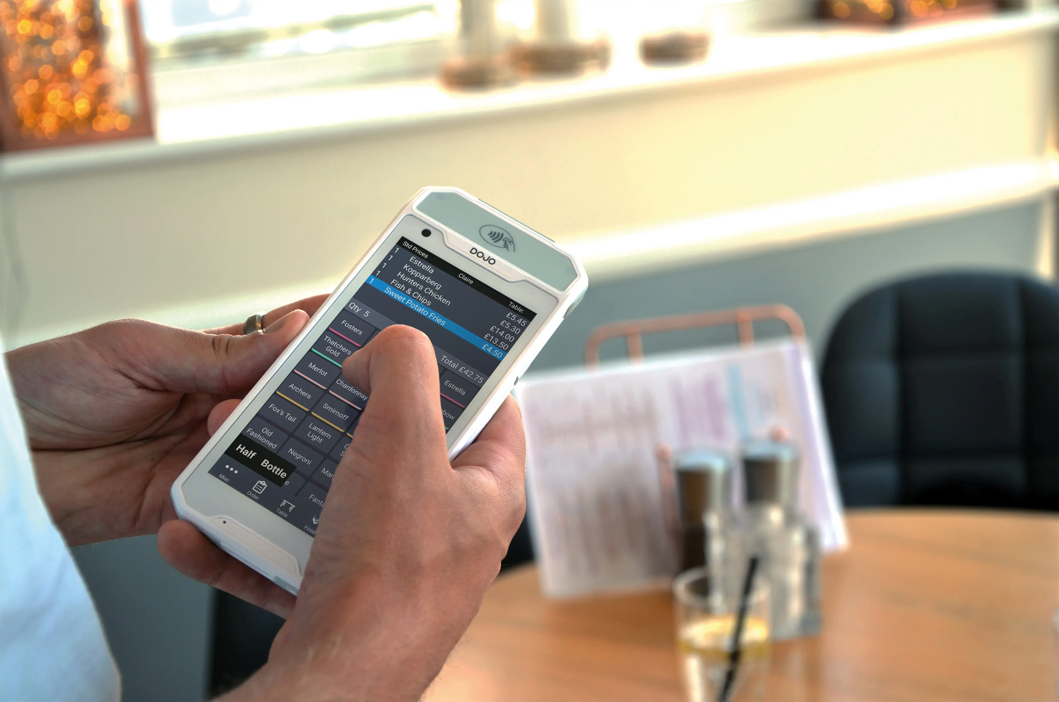 PocketTouch handheld paired with a Dojo payment terminal for tableside checkout